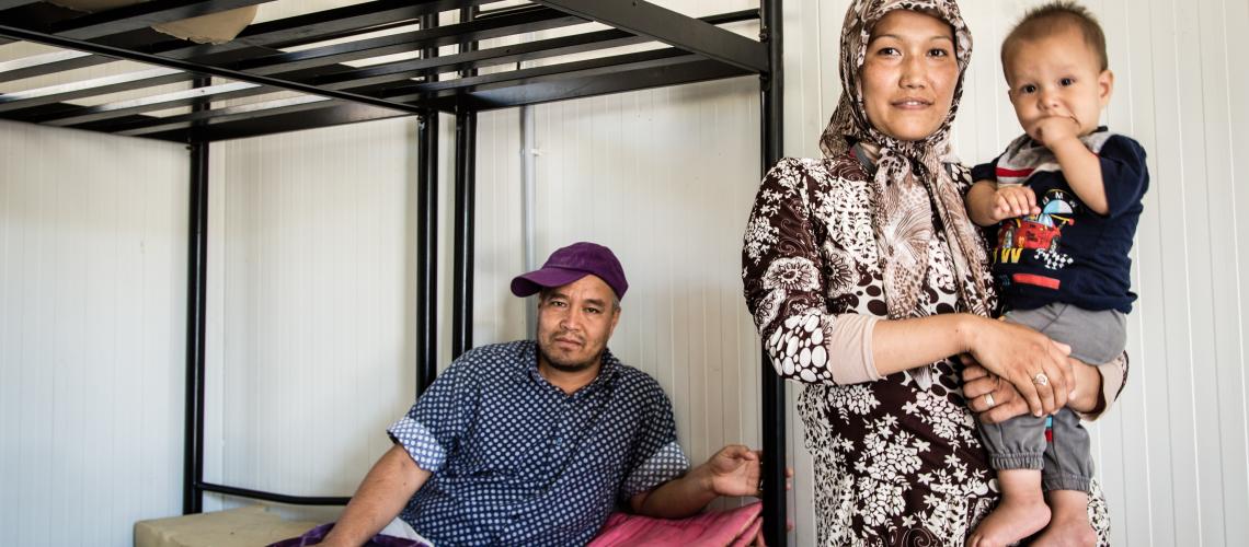 Family sitting and standing at bunkbed