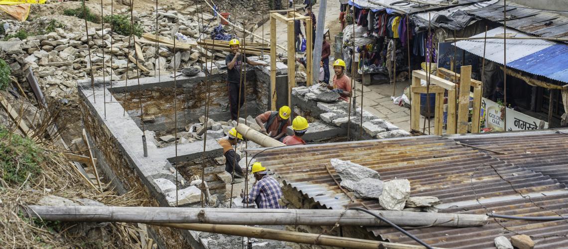 Men erecting a building