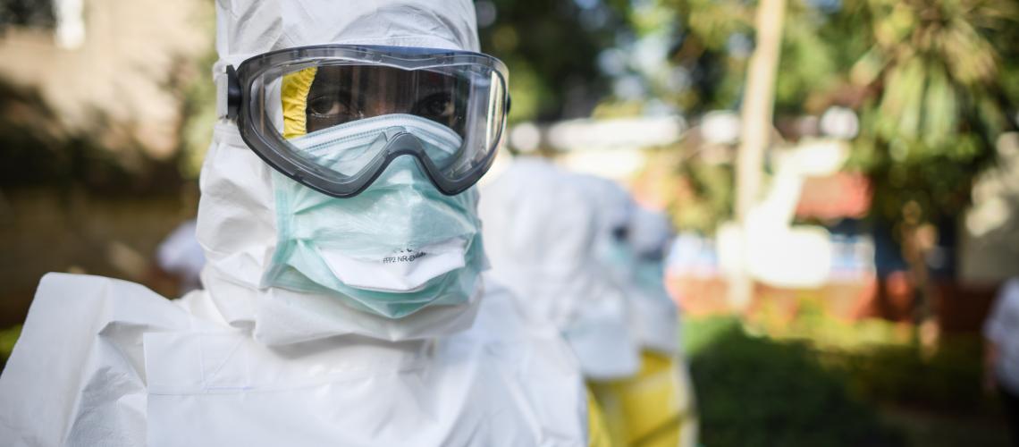 Medical person dressed in white with face covering