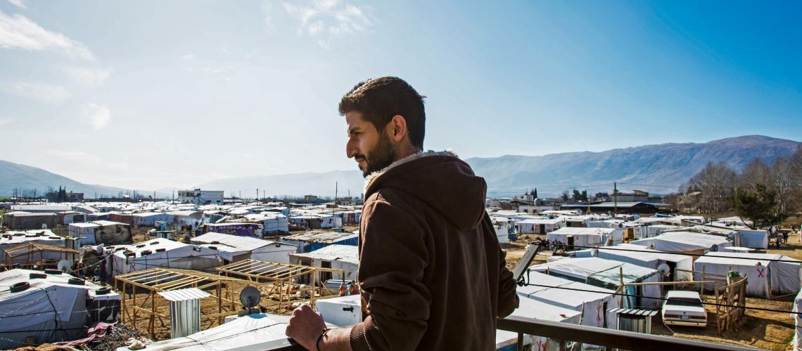 Man on roof of building overlooking town