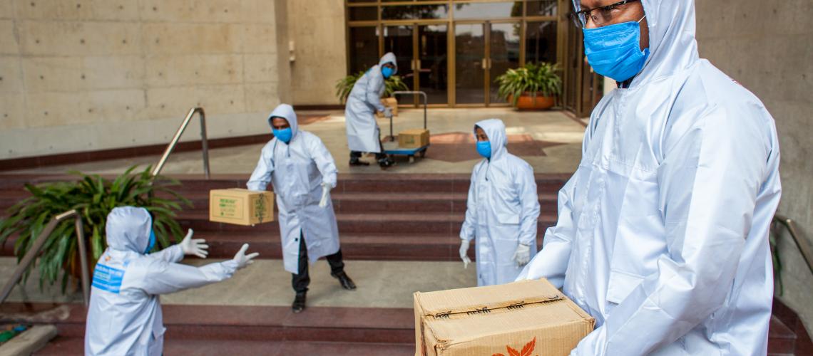 Emergency responders moving boxes