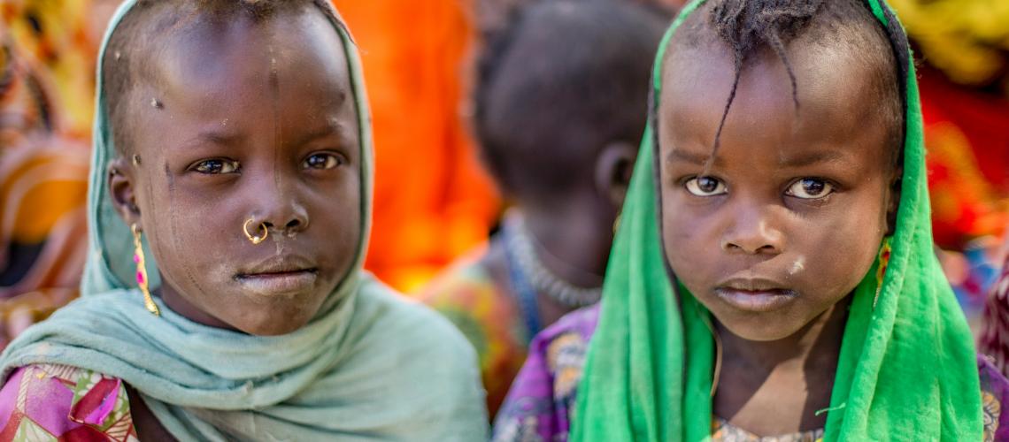 Two young children looking at the camera