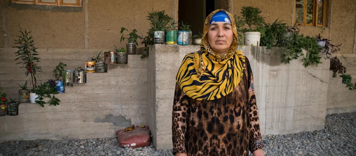 A woman standing in front of a house