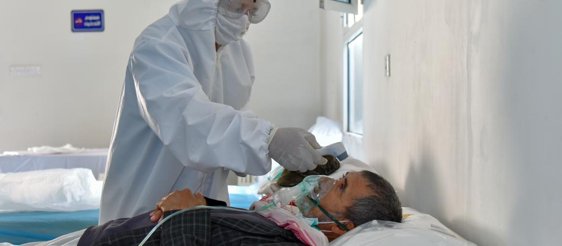 patient getting checked by PPE kit nurse