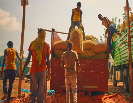 Men moving bags of food off a truck