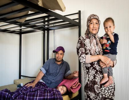 Family sitting and standing at bunkbed