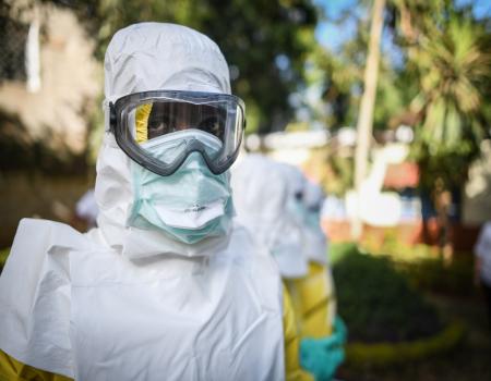 Medical person dressed in white with face covering