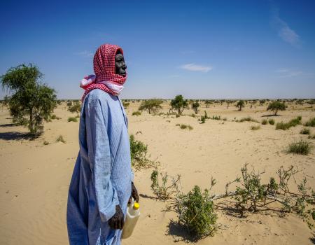 Woman standing in a desert