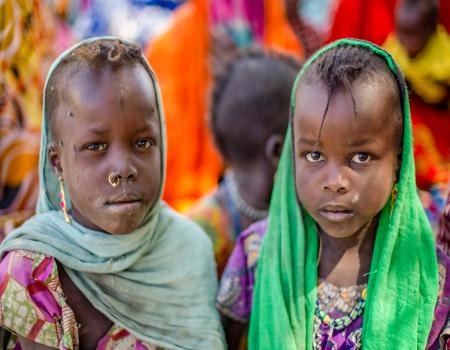 Two young children looking at the camera