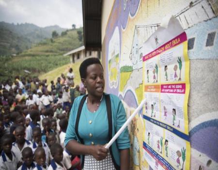 Woman pointing out information on a board