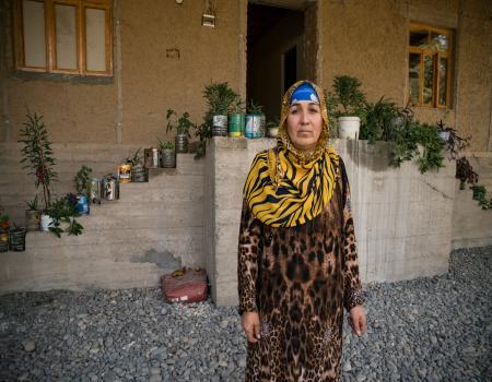 A woman standing in front of a house