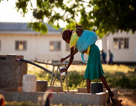 girl filling water from tap