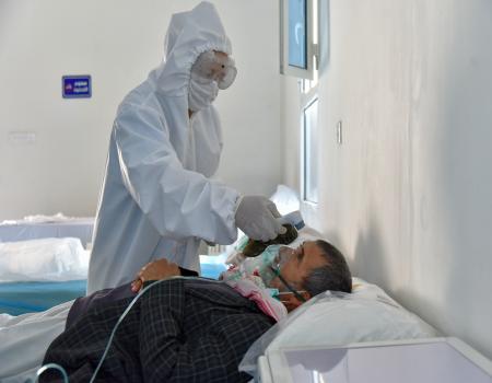 patient getting checked by PPE kit nurse