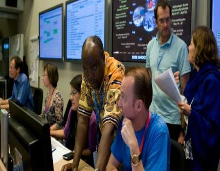 4 people looking at a computer screen